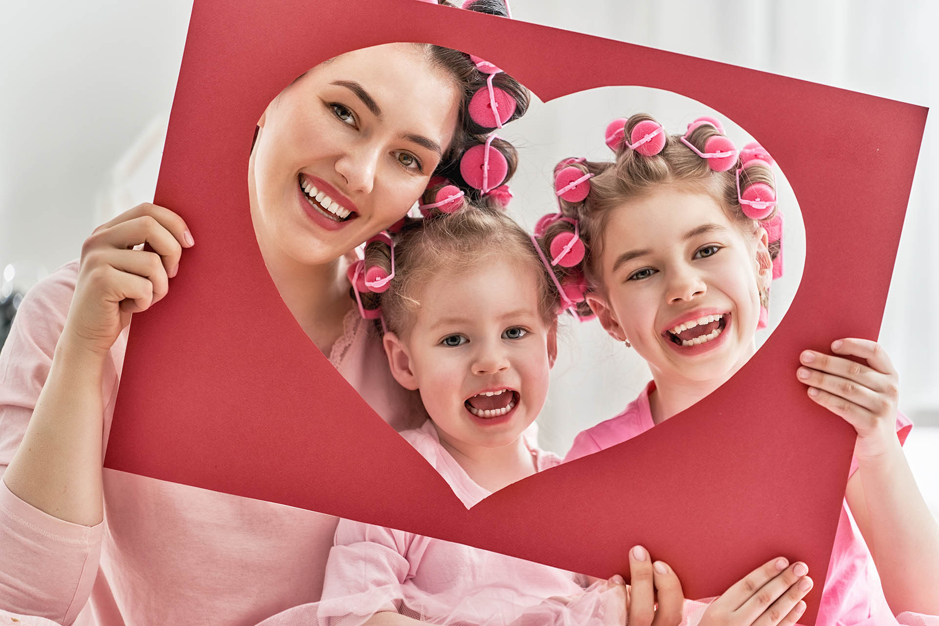 Happy smiling mom knows that ozone dental therapy is safe and effective for her young daughters