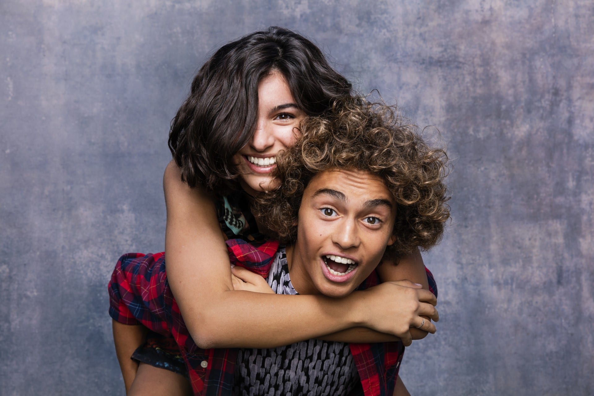 teens in a photo booth wearing Invisalign Teen® uses clear aligners