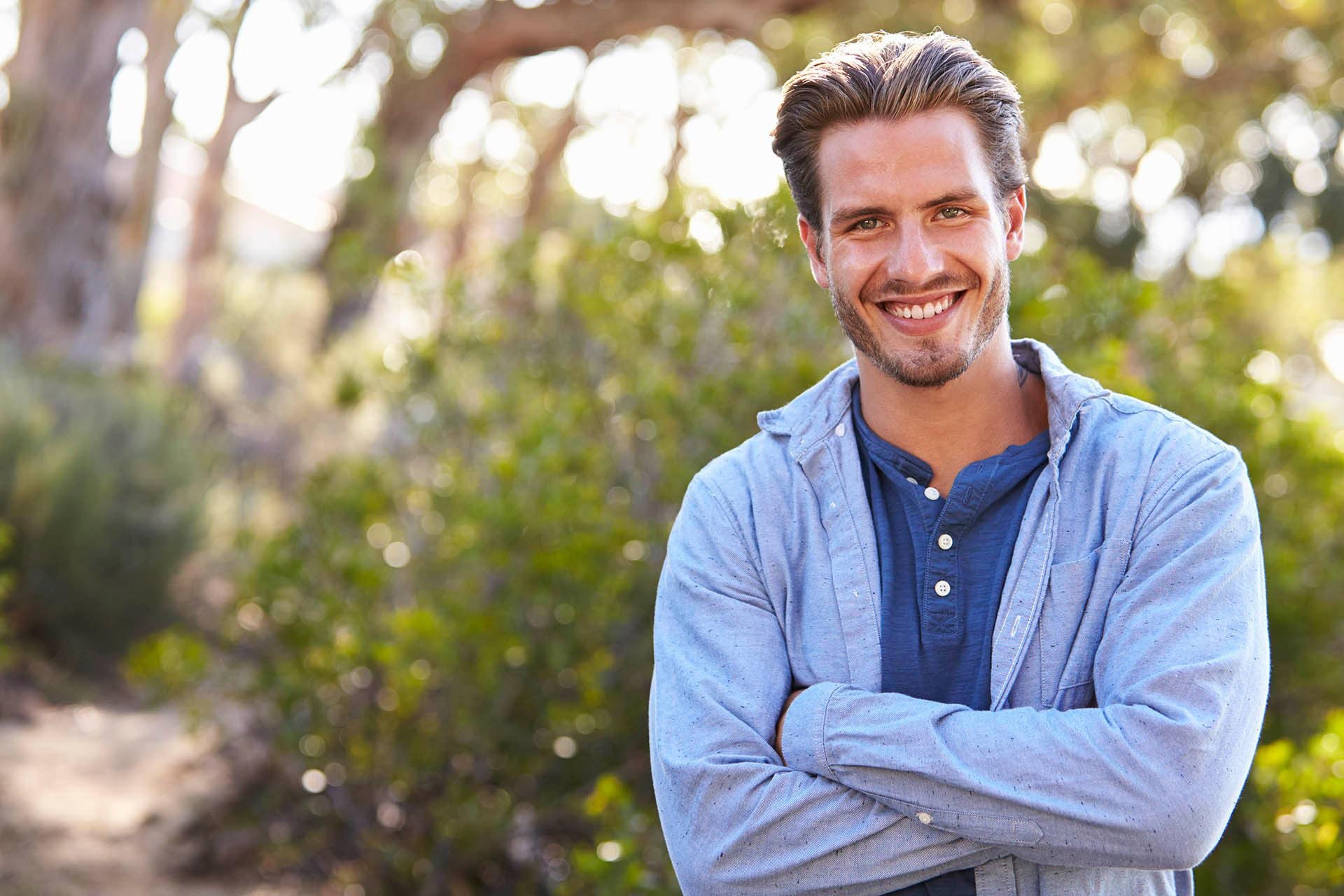 Man outdoors shows off his smile from the best dentist Carmichael, CA