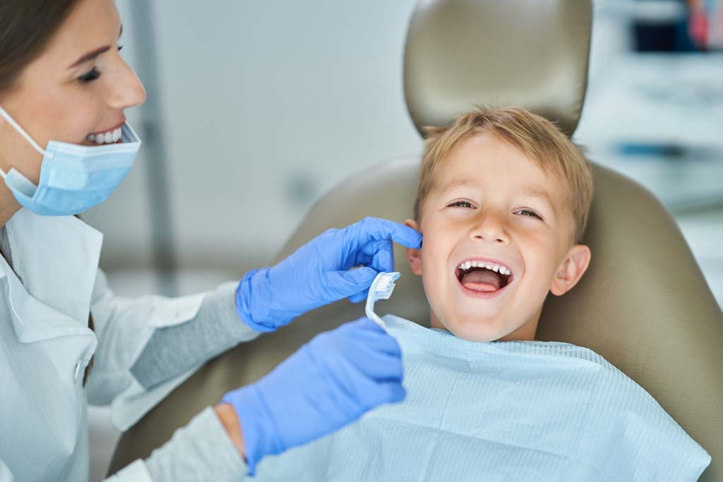 Young boy in dental chair with a big smile because Dr. Digiorno was able to reverse his cavity and avoid a filling by using holistic dentistry in Gold River, CA