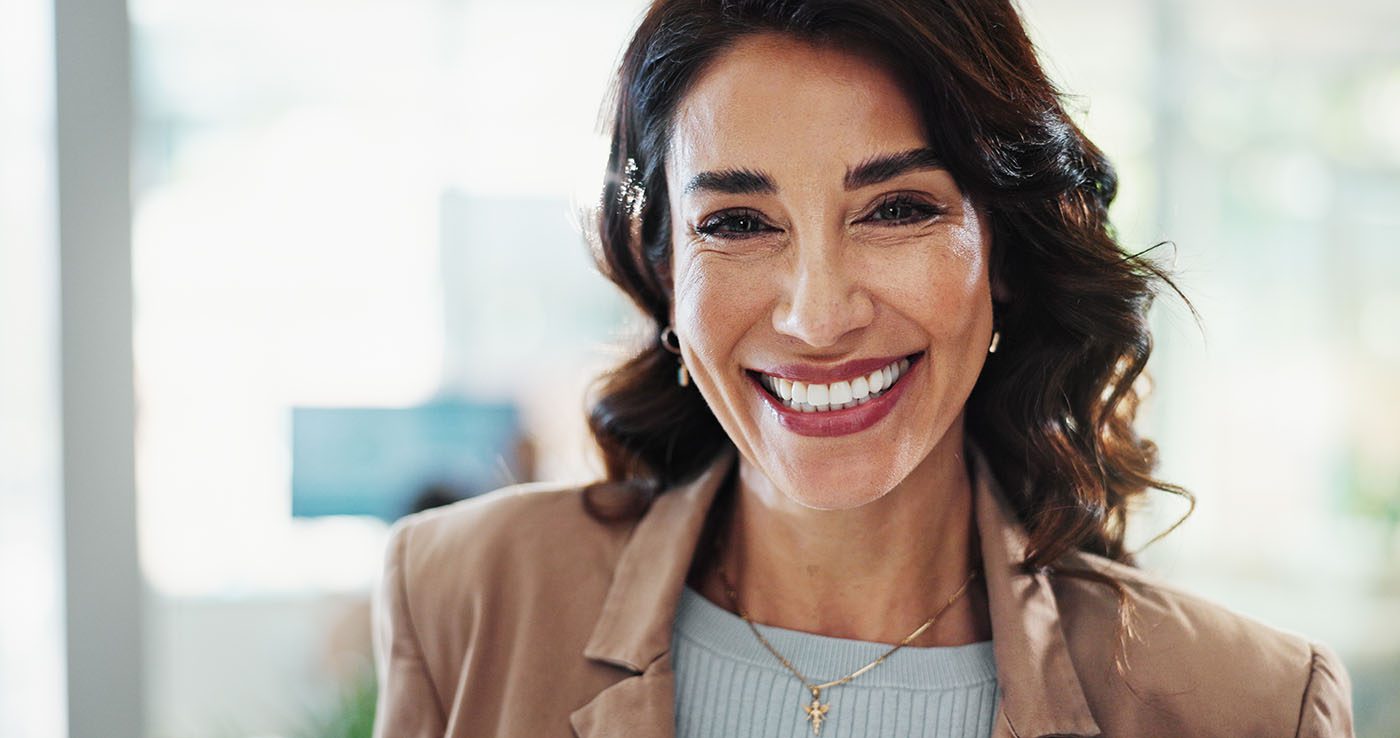 confident businesswoman smiles in her office