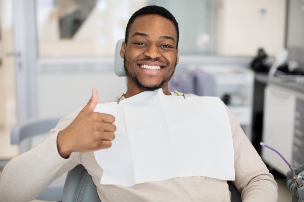 person smiling after getting porcelain veneers instead of dental bonding