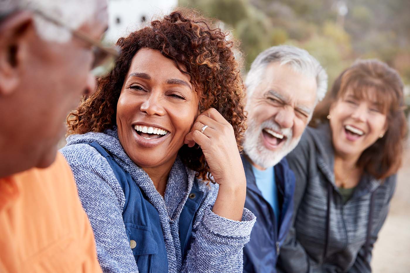 group of senior friends laughing outside